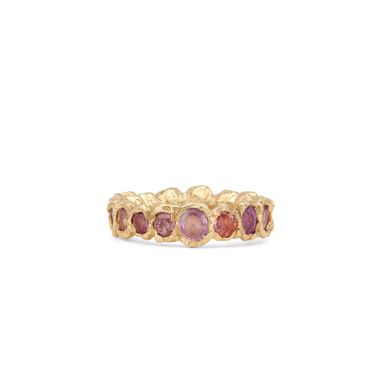 Our colorful statement, Freja Rainbow ring in 14-karat gold with 17 Sapphires in a palette of pink shades. This cocktail ring has Fie Isolde's raw signature finish resembling liquid gold.  PRODUCT DETAILS:   Ring in 14-karat gold with multi-colored Sapphires.  Handmade in Los Angeles SIZE & MEASUREMENTS:  Ring hight: 6 mm  