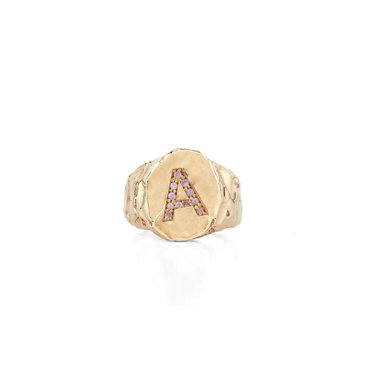 The Violet Signet Ring is made in 14-karat gold with a letter set with diamonds in Fie Isolde's raw signature look. It is an amazing statement piece that you will never take off once put on. The cigar shaped band makes it comfortable to wear but still maintain the chunky look. The signet ring has a high polished finish making the gold look like liquid. PRODUCT DETAILS:   Ring in 14-karat gold with diamonds.  Handmade in Los Angeles 