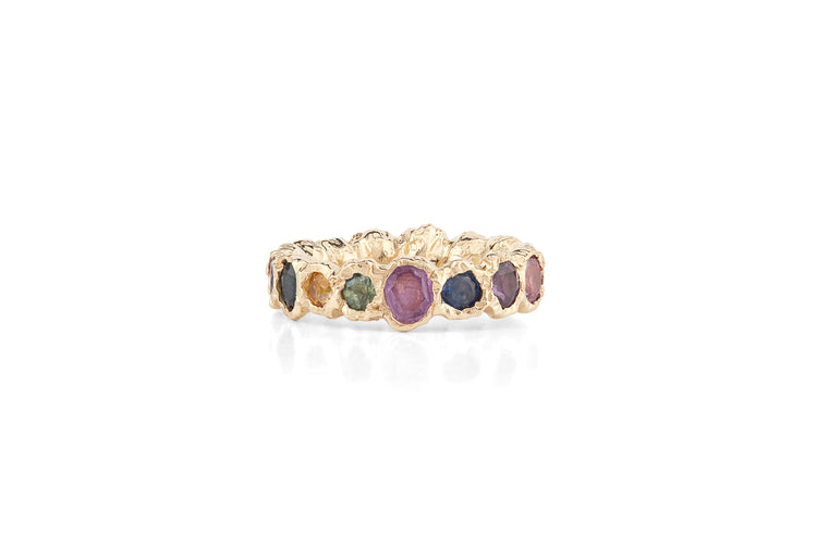 Our colorful statement, Freja Rainbow ring in 14-karat gold with 17 Sapphires in a palette of light multi-colored shades. This cocktail ring has Fie Isolde's raw signature finish resembling liquid gold. PRODUCT DETAILS: Ring in 14-karat gold with multi-colored Sapphires. Handmade in Los Angeles SIZE & MEASUREMENTS: Ring hight: 6 mm