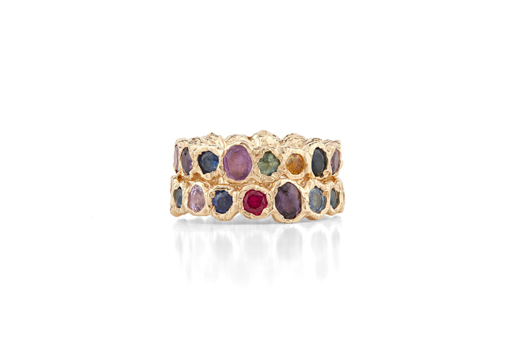 Our colorful statement, Freja Rainbow ring in 14-karat gold with 17 Sapphires in a palette of light multi-colored shades. This cocktail ring has Fie Isolde's raw signature finish resembling liquid gold. PRODUCT DETAILS: Ring in 14-karat gold with multi-colored Sapphires. Handmade in Los Angeles SIZE & MEASUREMENTS: Ring hight: 6 mm