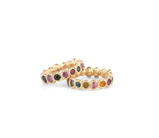 Our colorful statement, Freja Rainbow ring in 14-karat gold with 34 Sapphires in multi-colored shades. This cocktail ring has Fie Isolde's raw signature finish resembling liquid gold. The rings are not attached to each other, they can be worn stacked or independently. PRODUCT DETAILS: Ring in 14-karat gold with multi-colored Sapphires. Handmade in Los Angeles SIZE & MEASUREMENTS: Ring hight double: 12 mm